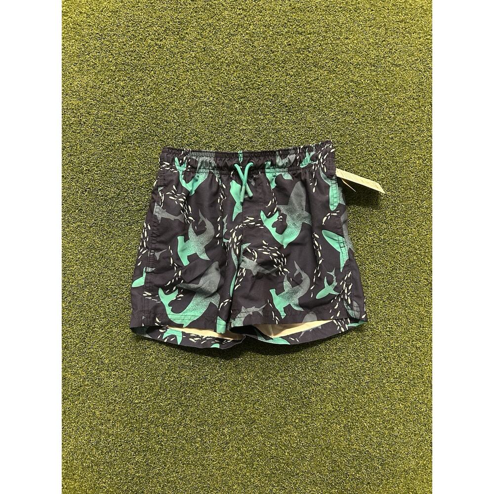 pair of Cat & Jack Surfing Shark swim trunks